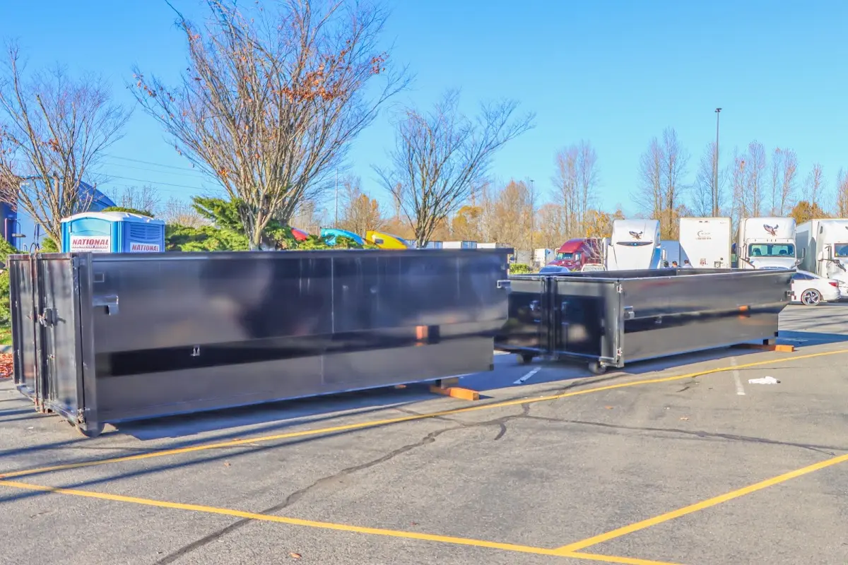 Professional dumpster rental service with roll-off container on residential driveway in Perth Amboy